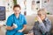 Medical nurse helping senior woman in nursing home