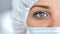 Medical nurse or scientist in surgical mask on blurred background in a hospital or lab