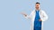 Medical offer. Happy male physician pointing aside and showing copy space with his open palm, panorama, blue background