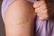 Medical patch, bandage or plaster on a mans shoulder after vaccination