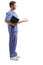 Medical person in a blue uniform holding a clipboard and gesturing with hand