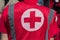 Medical personnel in uniform with the sign of the Red Cross provide medical assistance