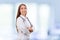 Medical physician doctor woman over blue clinic background.