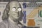 Medical pills on the eyes of Benjamin Franklin on  bill of one hundred dollars close-up. insurance medicine,  high cost of drugs