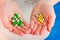 Medical pills green, yellow, grey in human\'s hands