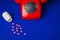 Medical pills and red telephone blue background