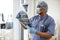 Medical practitioner holding CT scan images in exam room