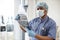 Medical practitioner holding CT scan images in exam room