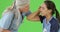 A medical professional attends to an injured soccer player on green screen