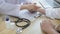 Medical professional measures the pulse of a male patient`s wrist to check his heart rate in the hospital`s examination room