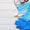 Medical protective antiviral concept. Protective blue medical mask, blue gloves, antiseptic spray