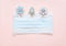 medical protective face masks as a gift with a red ribbon on a green background. Christmas and New Year 2021 decor painted firs an