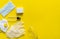 Medical protective mask, respirator ffp, soap, rubber gloves, antiseptic and protective glasses lie on a yellow