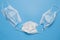 Medical protective masks for whole family on blue background. Disposable face masks for adults and children. Healthcare and