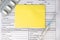 Medical questionnaire of the patient. Thermometer and syringe. Yellow blank sheet with space for text. Medical concept