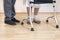 Medical rehabilitation balconies. Grandma learns to walk with the help of a walker and assisted by a nurse.