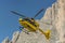 Medical rescue helicopter flying rescue injured climber on the Tre Cime. Italy, Dolomites