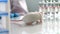 Medical research scientist examines laboratory mice. She works in a light laboratory.