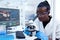 Medical researcher with african ethnicity using microscope