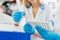 Medical and science background. Hands of laboratory assistants holding rack of sample tubes for blood test analysis