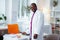 Medical scientist wearing white jacket standing near working table