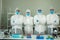 Medical scientists wearing protective suit and face mask  diagnosis vaccine virus in science clinical