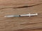 Medical Small Syringe On The Rough Wood Background