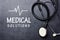 Medical solutions text on blackboard with stethoscope and heartbeat rate