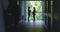 Medical staff and patients walk in dark clinic corridor