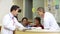 Medical Staff Working At Busy Nurses Station