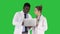 Medical staff working in front of a grey laptop while standing on a Green Screen, Chroma Key.