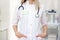 Medical staff working at the hospital: cropped woman doctor in white uniform. Mockup for doctor name. healthcare and medical exams