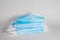 Medical sterile disposable masks. Neat stack of blue medical masks on a white background