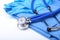 Medical stethoscope, Gloves, RX prescription on blue doctor uniform closeup. Medical tools and instruments shop, blood