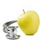Medical stethoscope with green apple isolated on white background. Concept for diet, healthcare, nutrition or medical insurance