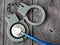 Medical stethoscope and handcuffs on wooden background