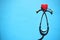 Medical stethoscope head and red heart on blue background. heart disease, rate measure, Cardio therapeutist, arrhythmia concept