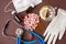 Medical still life: pink pills, fish oil, medical mask, a Cup of water with lemon, stethoscope, disposable gloves and medicine in