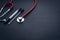 Medical swab and stethoscope closeup on black background