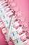 Medical syringe and ampoules on a pink background, close-up