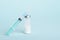 Medical syringe, glass ampoule on blue background with copy space, vaccination