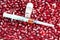 Medical syringe with medicine on pomegranate berries