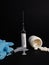 medical syringe with vaccine on a black background, medical syringes, gloves and needles