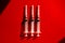 Medical syringes needles on red background with highlights and shadows