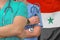 Medical team standing arms crossed on Syria flag background. Health care, surgery and medical concept in Syria