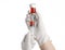 Medical theme: doctor\'s hand in a white glove holding a red vial of liquid for injection isolated on white background