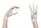 Medical theme: doctor\'s hand in white gloves holding a transparent container with the analysis of urine on a white background