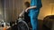 Medical worker bringing depressed old woman in wheelchair to room, loneliness