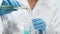 Medical worker pouring yellow liquid into test tube, perfume production