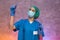 Medical worker in protective costume holding red test tubes in hands in laboratory